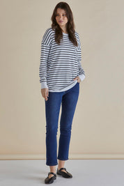 A model wearing the Sophie Knit Jumper in colour Blkstripe (White), from the front, showing the whole outfit