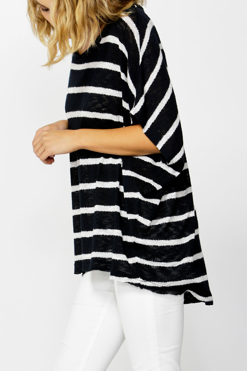 A model wearing the Grace Oversized Knit in colour InkWhite (Blue), from the front, cropped image
