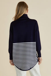 A model wearing the Fleur Roll Neck Jumper in colour Navystripe (Blue), from the back