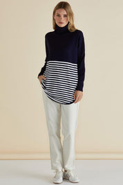 A model wearing the Fleur Roll Neck Jumper in colour Navystripe (Blue), from the front, showing the whole outfit