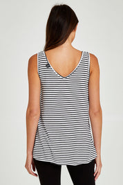 Model Madeline wearing size 10 of the Sirena Reversible Tank in colour Noirstripe (White), from the back