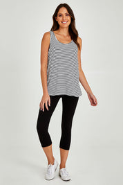 Model Madeline wearing size 10 of the Sirena Reversible Tank in colour Noirstripe (White), from the front, showing the whole outfit