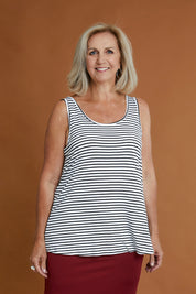 Model Sandy wearing size 10 of the Sirena Reversible Tank in colour Noirstripe (White), from the front, cropped image