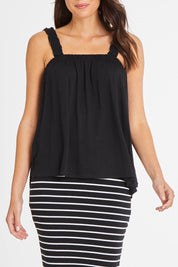 Model Madeline wearing size 10 of the Susie Tank in colour Black (Black), from the front, cropped image