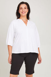 Model Poppy wearing size 16 of the Bermuda Bengaline Short in colour Black (Black), from the front, cropped image