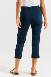 A model wearing the Crop Bengaline Pant in colour Navy (Blue), from the back