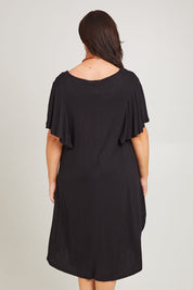 Model Poppy wearing size 16 of the Tahiti Frill Dress in colour Black (Black), from the back