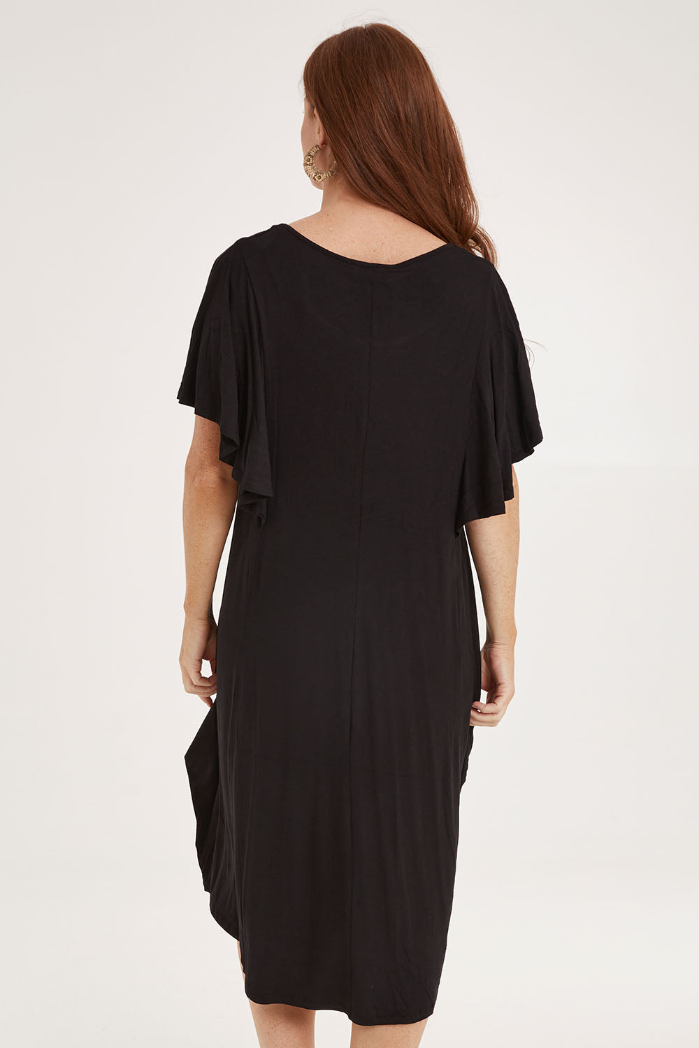 Model Sally wearing size 10 of the Tahiti Frill Dress in colour Black (Black), from the back