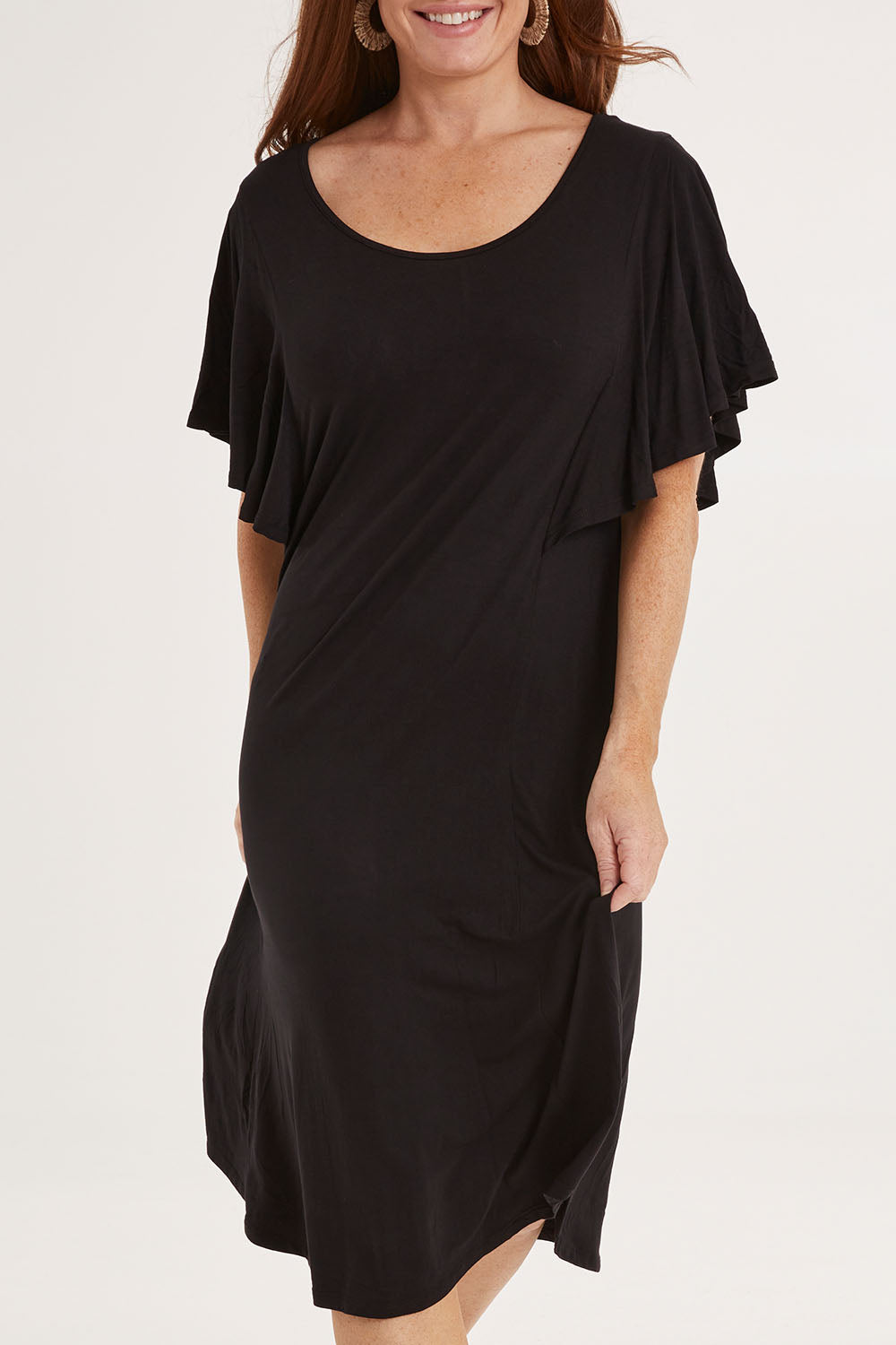 Model Sally wearing size 10 of the Tahiti Frill Dress in colour Black (Black), from the front, cropped image