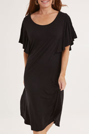 Model Sally wearing size 10 of the Tahiti Frill Dress in colour Black (Black), from the front, cropped image