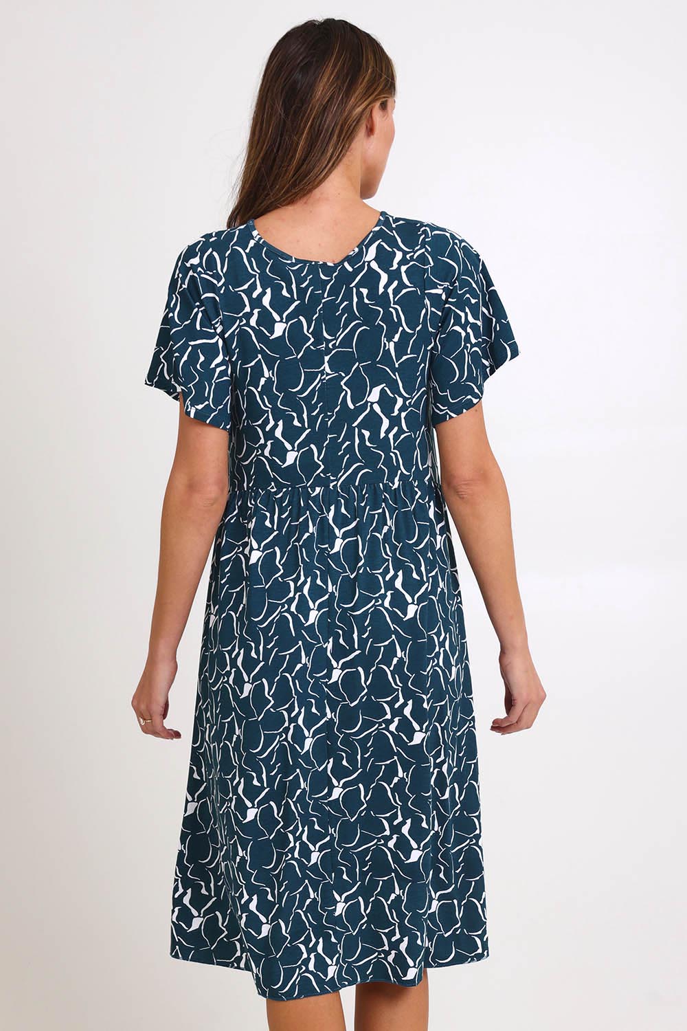 Model Madelinec wearing size 10 of the Donna Dress – Teal in colour Teal, from the back