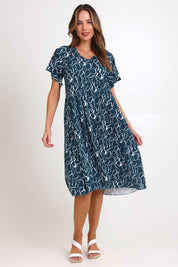 Model Madelinec wearing size 10 of the Donna Dress – Teal in colour Teal, from the front