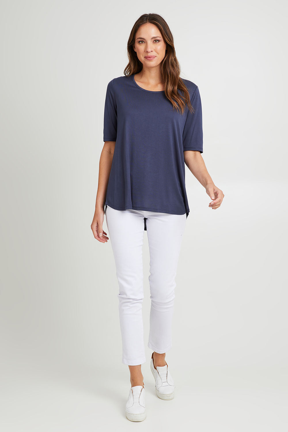 Model Madeline wearing size 10 of the Maya Tee in colour Dustyblue (Blue), from the front, showing the whole outfit