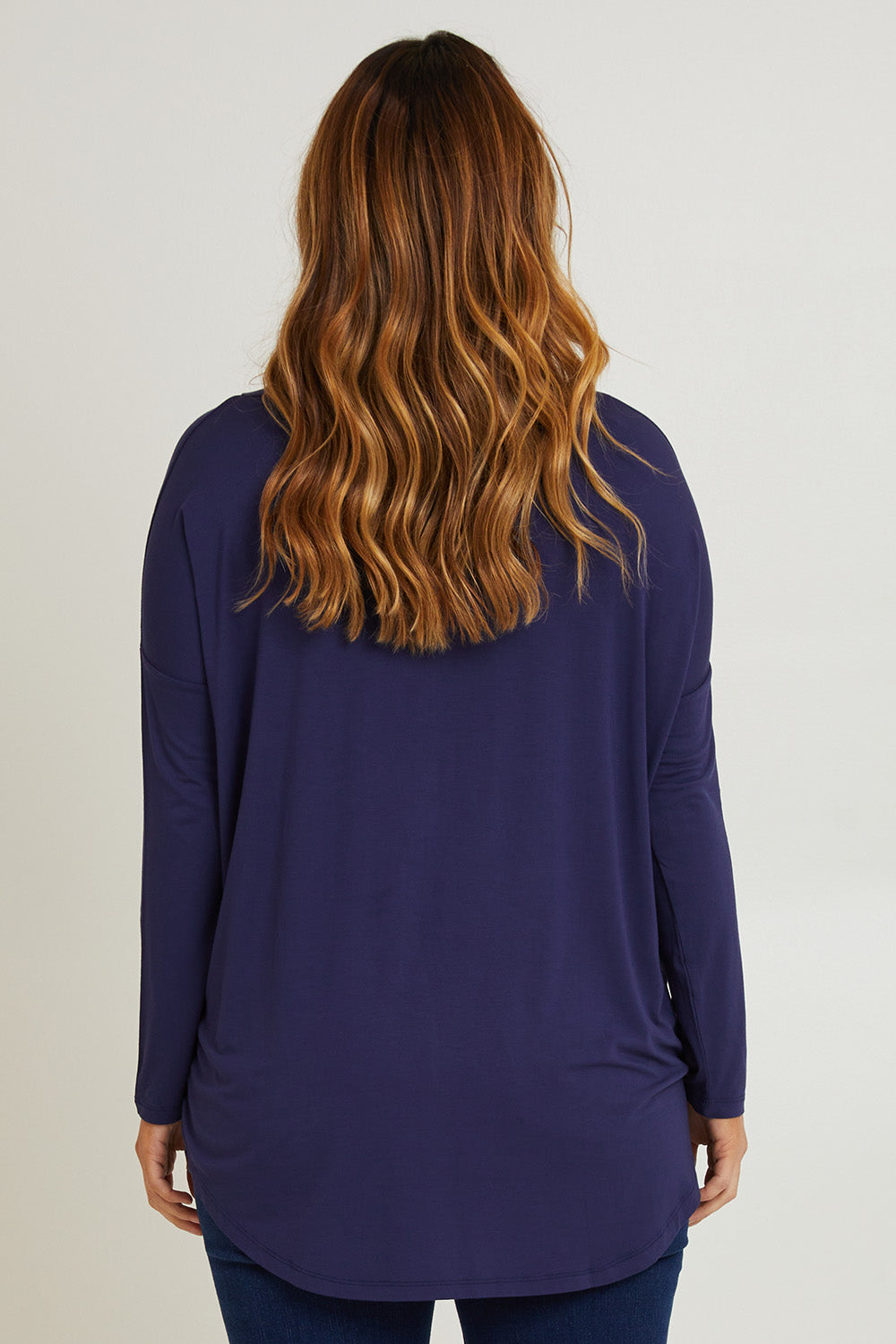 Model Laura wearing size 14 of the Cowl Bamboo Top in colour Navy (Blue), from the back