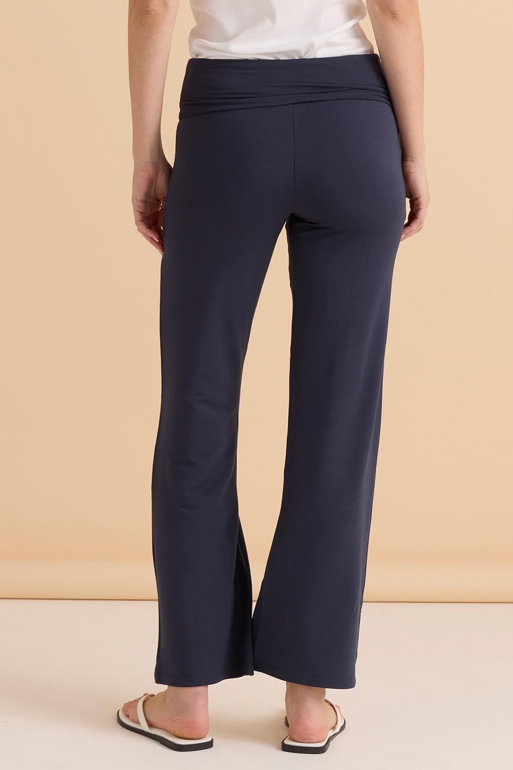 A model wearing the Houston Relaxed Pant in colour Petrol (Blue), from the back