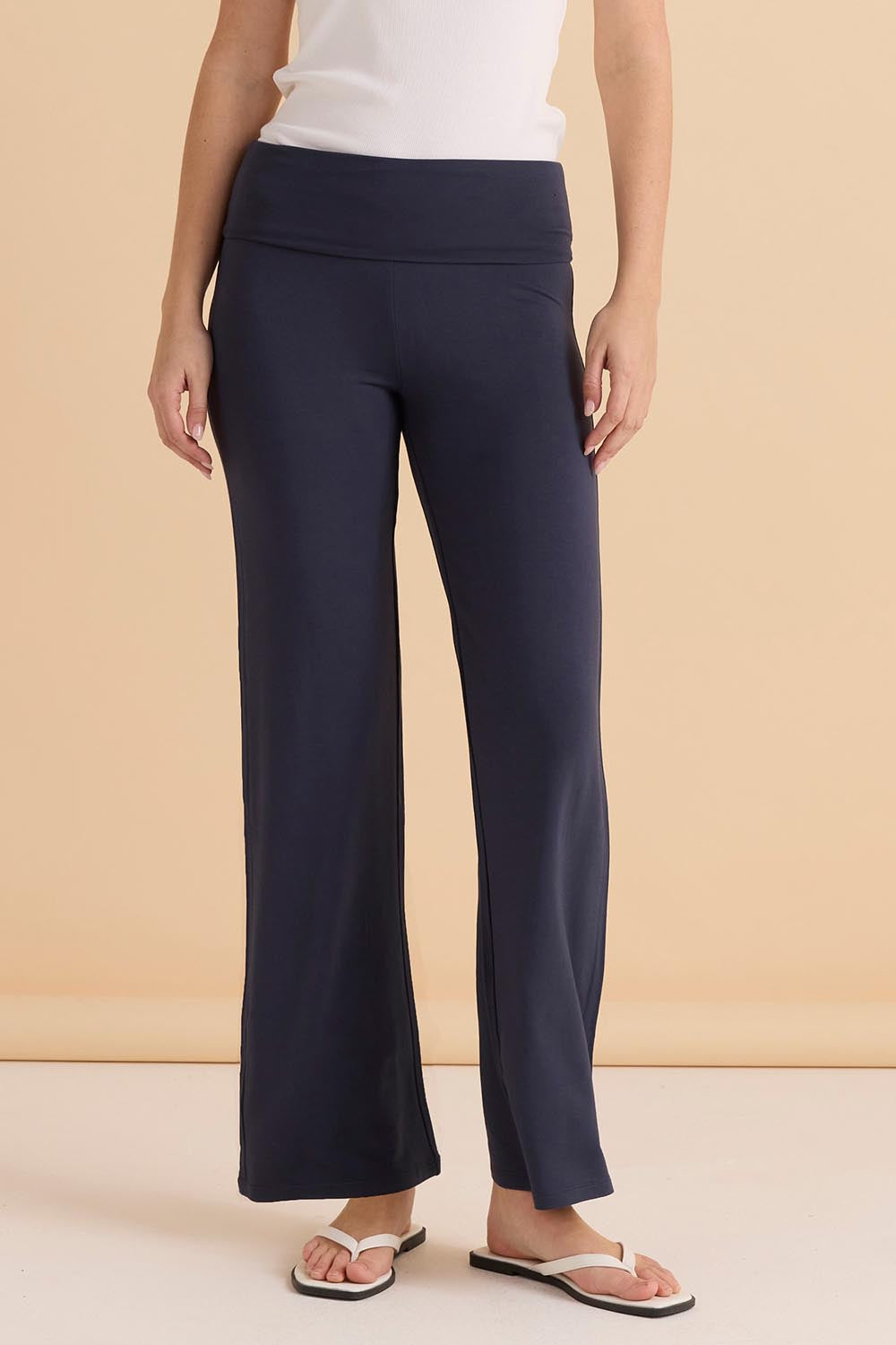 A model wearing the Houston Relaxed Pant in colour Petrol (Blue), from the front, cropped image