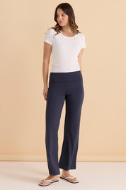 A model wearing the Houston Relaxed Pant in colour Petrol (Blue), from the front, showing the whole outfit