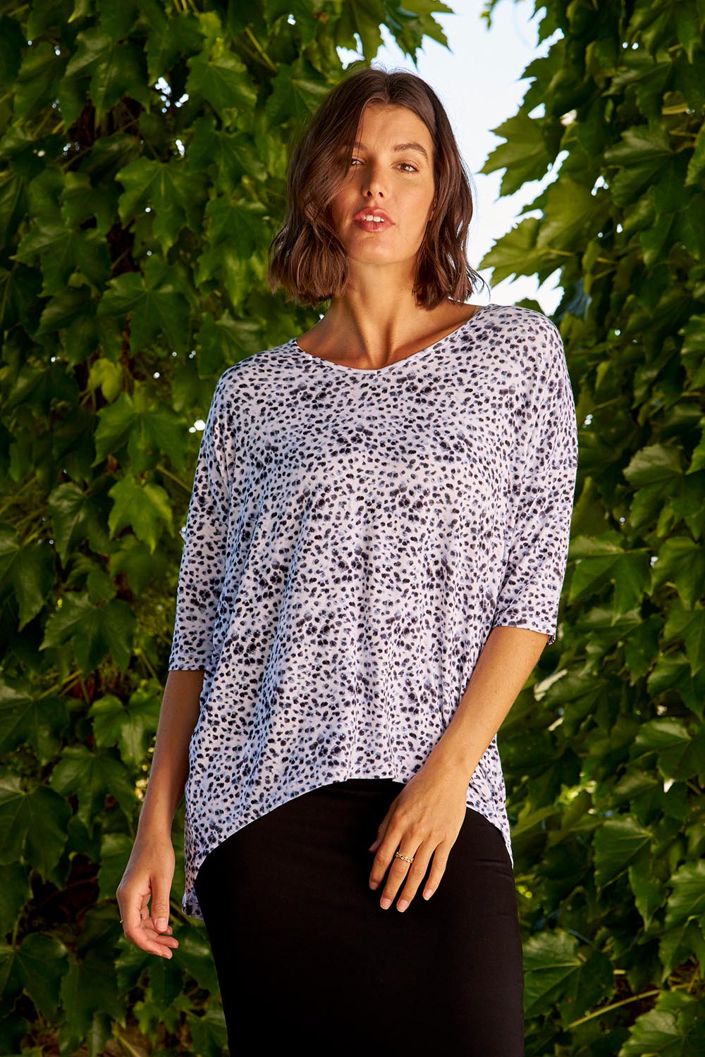 A model wearing the Brielle Bamboo Vin colourNeck Tee - Snowleop (White), from the front, showing the whole outfit