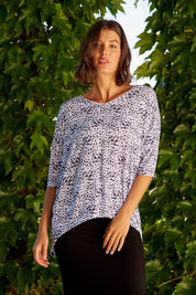 A model wearing the Brielle Bamboo Vin colourNeck Tee - Snowleop (White), from the front, showing the whole outfit
