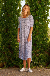 A model wearing the Marlene Bamboo Dress in colour Snowleop (White), from the front, showing the whole outfit
