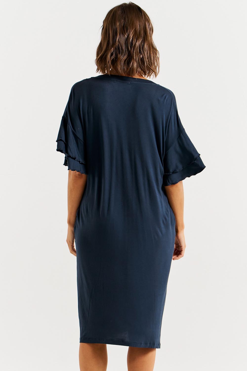 A model wearing the Mykonos Bamboo Dress in colour Petrol (Blue), from the back