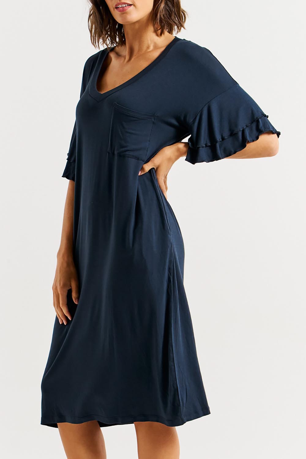 A model wearing the Mykonos Bamboo Dress in colour Petrol (Blue), from the front, cropped image