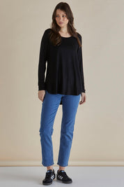 A model wearing the Yasmin Bamboo Long Sleeve Top in colour Black (Black), from the front, showing the whole outfit