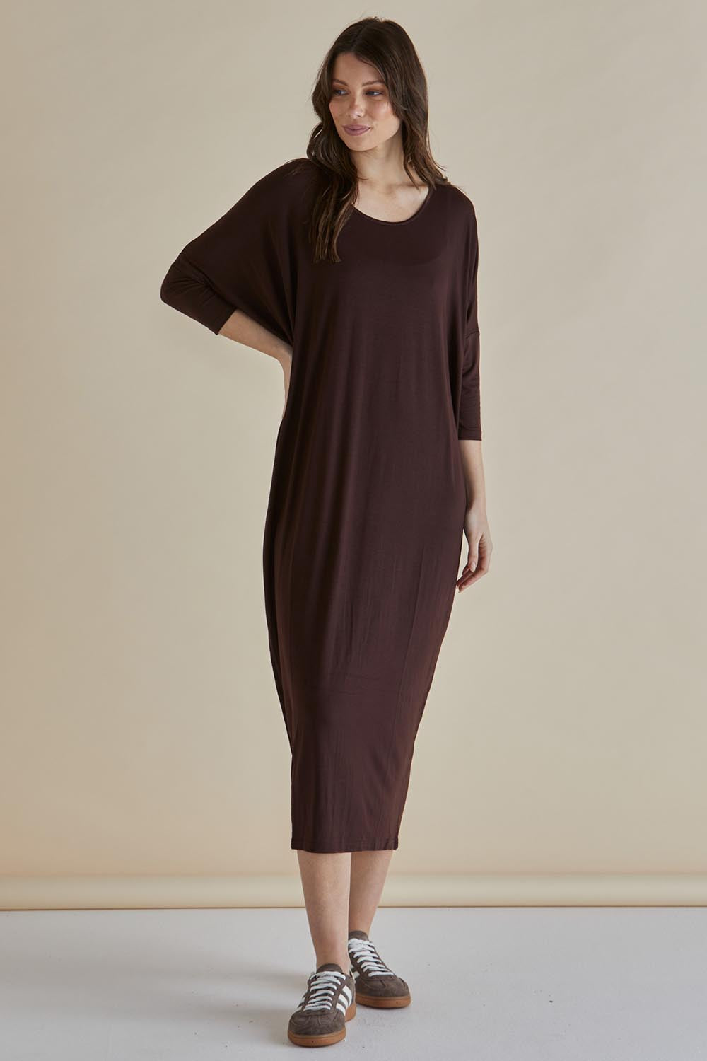 A model wearing the Melody Bamboo Dress in colour Chocolate, from the front, showing the whole outfit