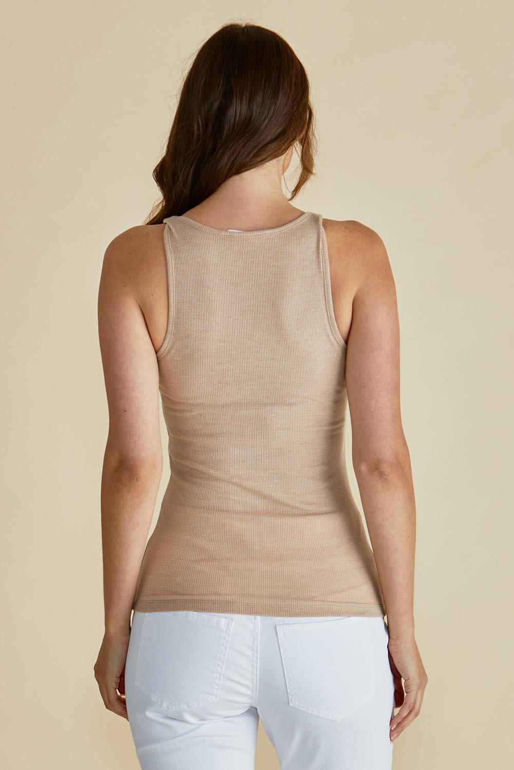 A model wearing the Tiana Cotton Blend Tank in colour Beige, from the back