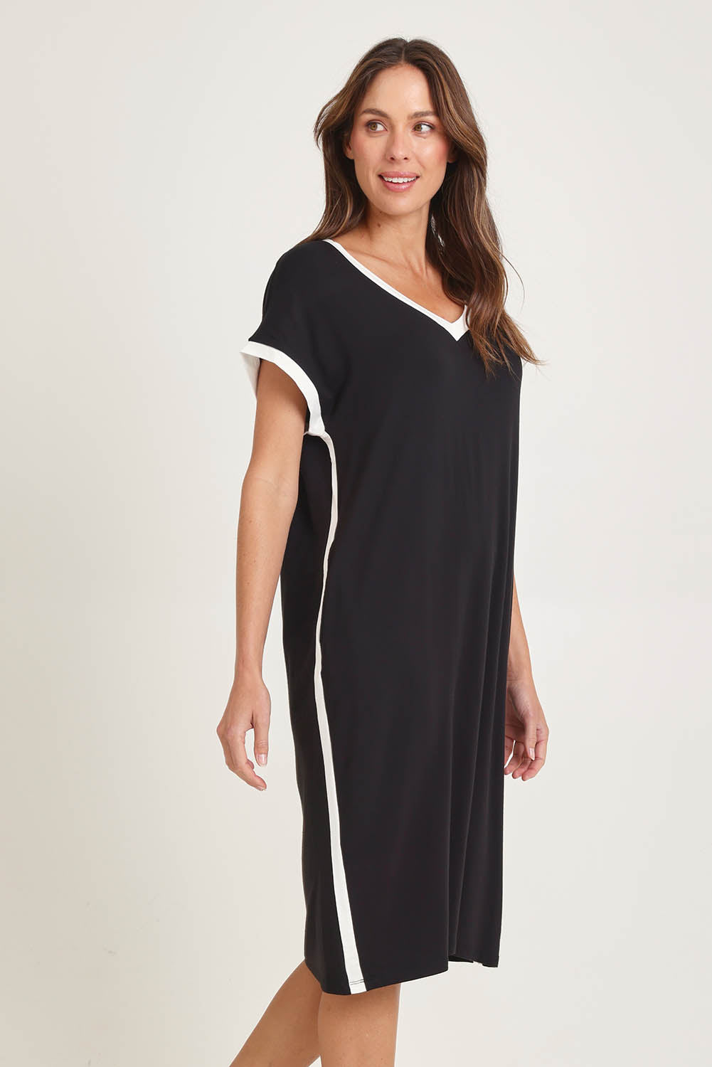 Model Madeline wearing size 10 of the Tula Tin colourShirt Dress - Black (Black), from the front, cropped image