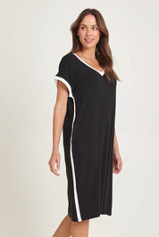 Model Madeline wearing size 10 of the Tula Tin colourShirt Dress - Black (Black), from the front, cropped image
