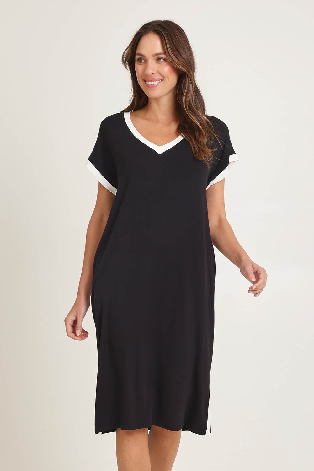Model Madeline wearing size 10 of the Tula Tin colourShirt Dress - Black (Black), from the front, cropped image