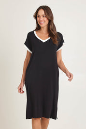 Model Madeline wearing size 10 of the Tula Tin colourShirt Dress - Black (Black), from the front, cropped image