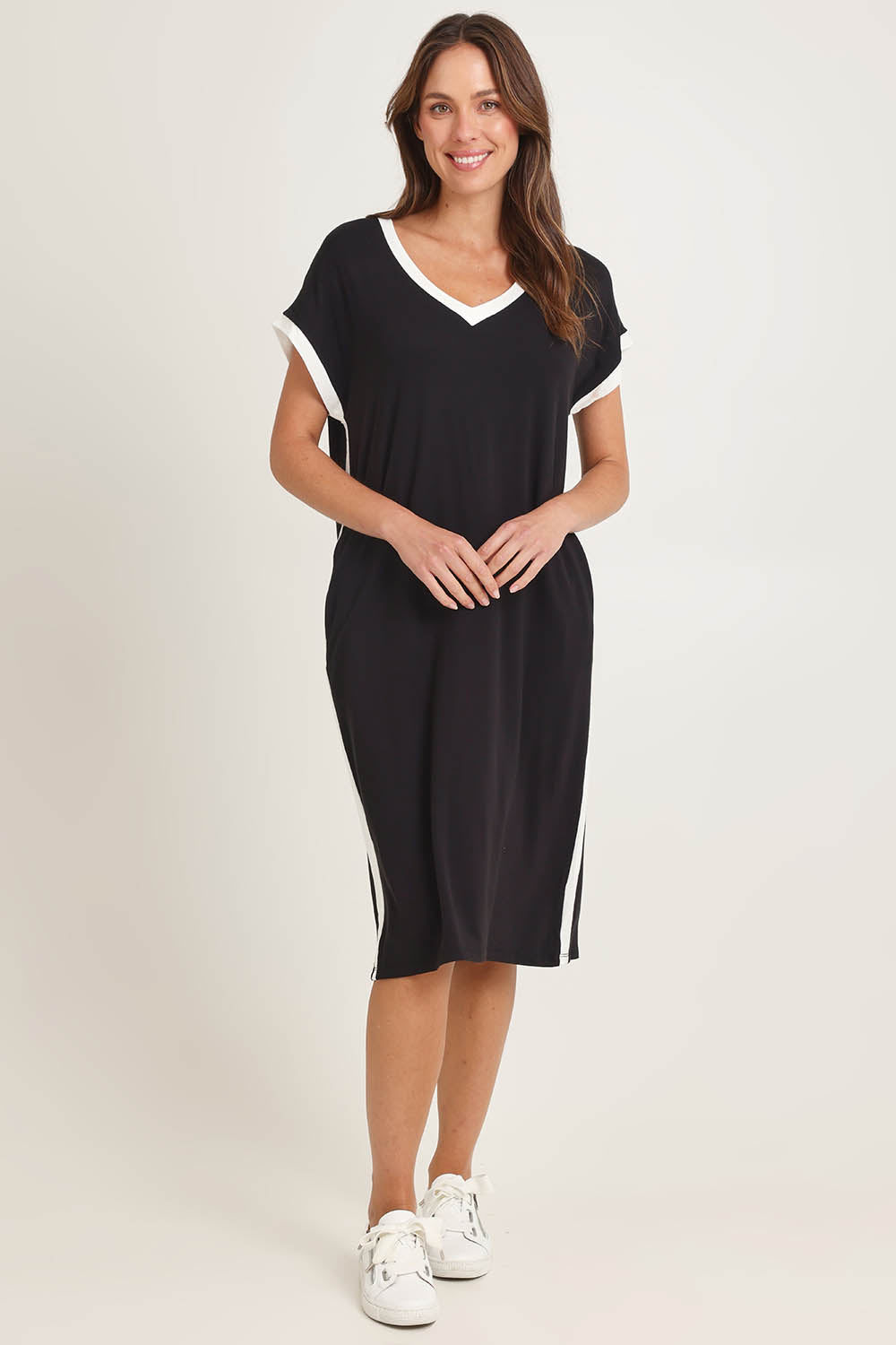Model Madeline wearing size 10 of the Tula Tin colourShirt Dress - Black (Black), from the front, showing the whole outfit