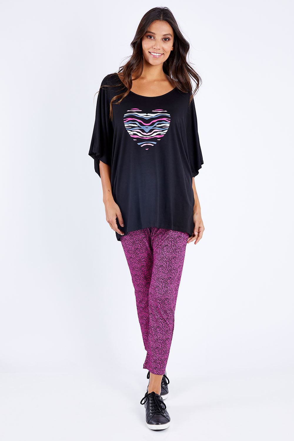 Model Vitoria wearing size 10 of the Maui Tee in colour Amore (Black), from the front, showing the whole outfit