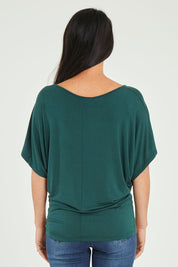 Model Katie wearing size 10 of the Maui Stretch Tee in colour Ivy (Green), from the back
