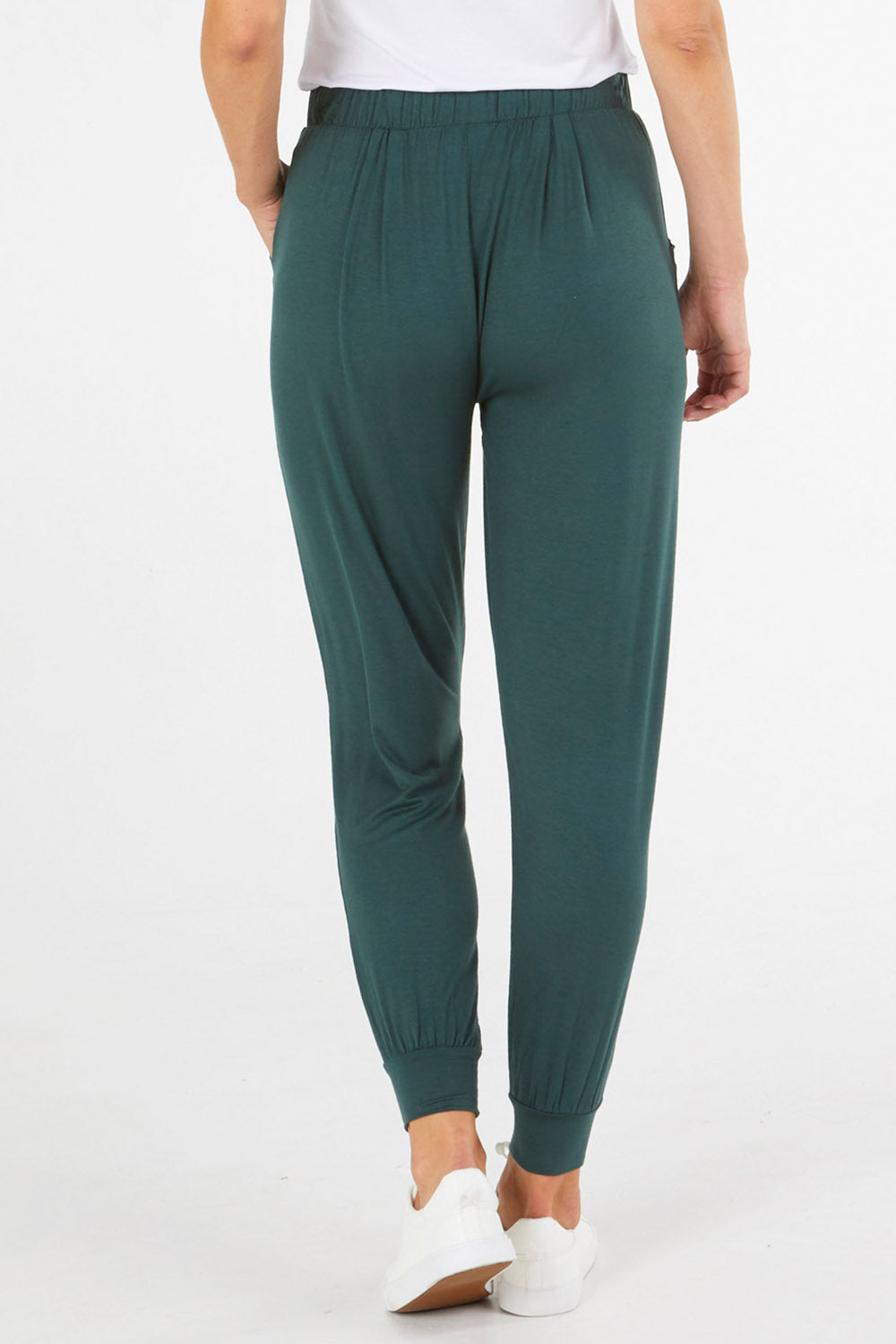 A model wearing the Paris Pant in colour Ivy (Green), from the back