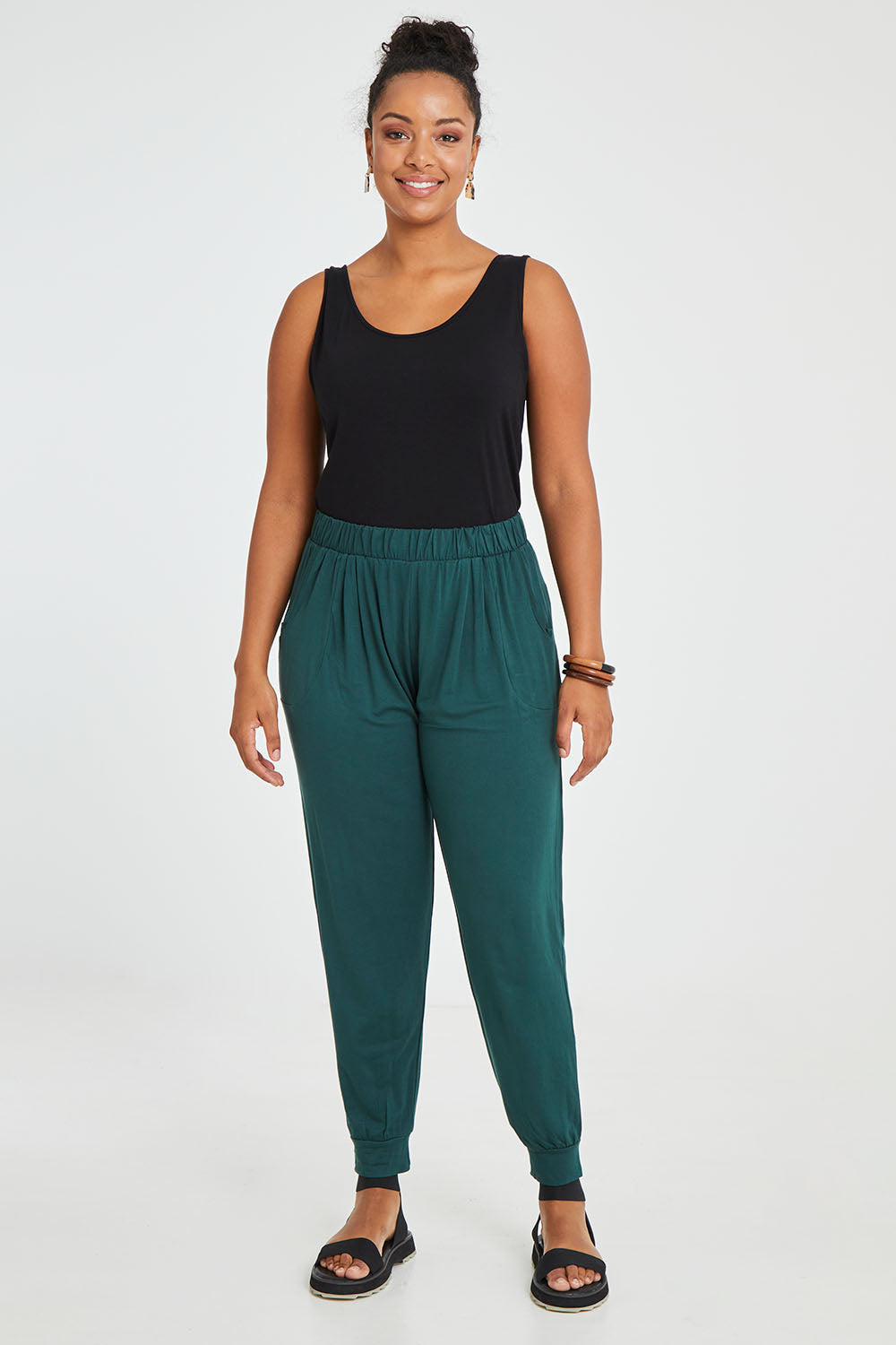 Model Noli wearing size 14 of the Paris Pant in colour Ivy (Green), from the front, showing the whole outfit