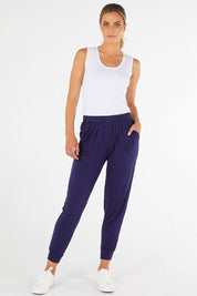 A model wearing the Paris Pant in colour Navy (Blue), from the front, showing the whole outfit