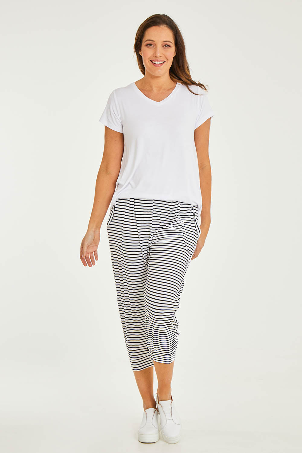 Model Georgia wearing size 10 of the Tokyo Stretch 3/4 Pant in colour Noirstripe (Black), from the front, showing the whole outfit