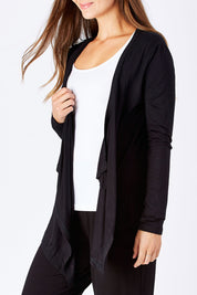 Model Anna wearing size 10 of the Melbourne Stretch Cardigan in colour Black (Black), from the front, cropped image