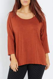 Model Laura wearing size 12 of the Milan 3/4 Sleeve Top in colour Terracotta (Red), from the front, cropped image