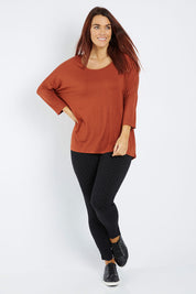 Model Laura wearing size 12 of the Milan 3/4 Sleeve Top in colour Terracotta (Red), from the front, showing the whole outfit