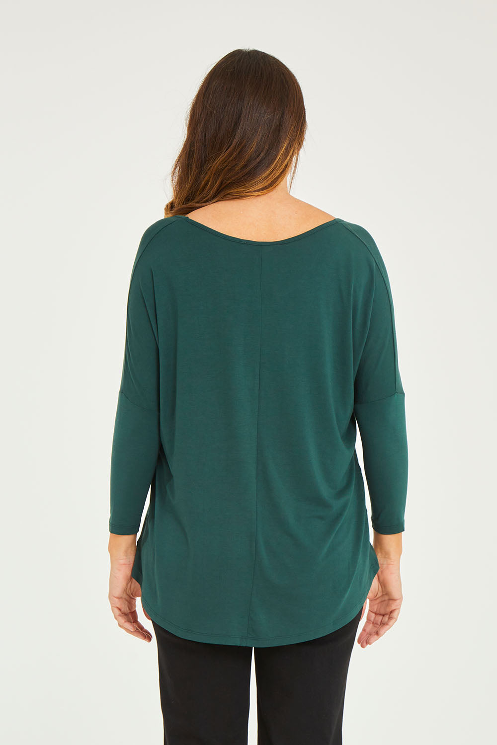 Model Georgia wearing size 10 of the Milan Stretch Top in colour Ivy (Green), from the back