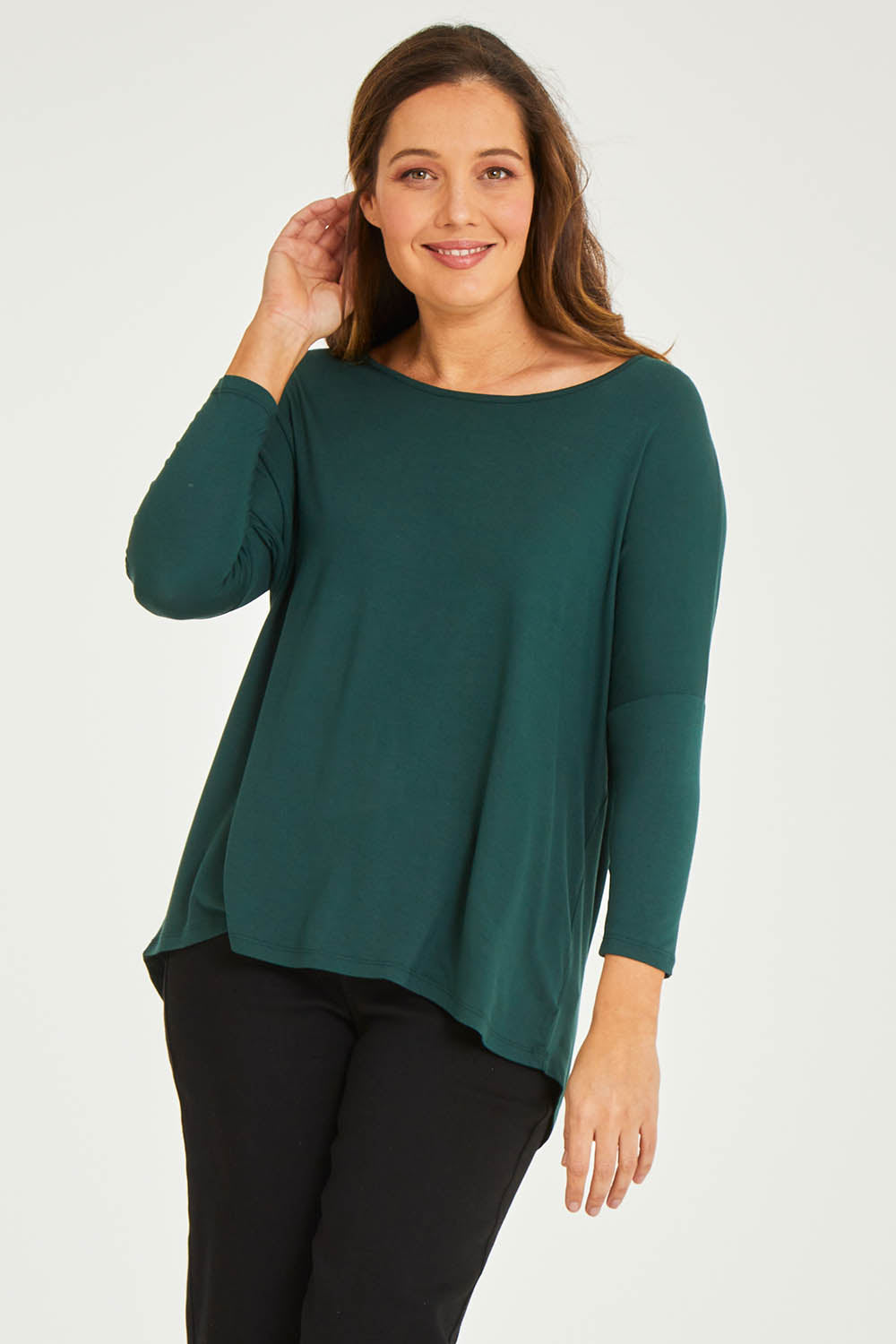Model Georgia wearing size 10 of the Milan Stretch Top in colour Ivy (Green), from the front, cropped image
