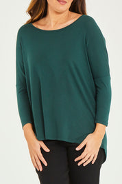 Model Georgia wearing size 10 of the Milan Stretch Top in colour Ivy (Green), from the front, cropped image