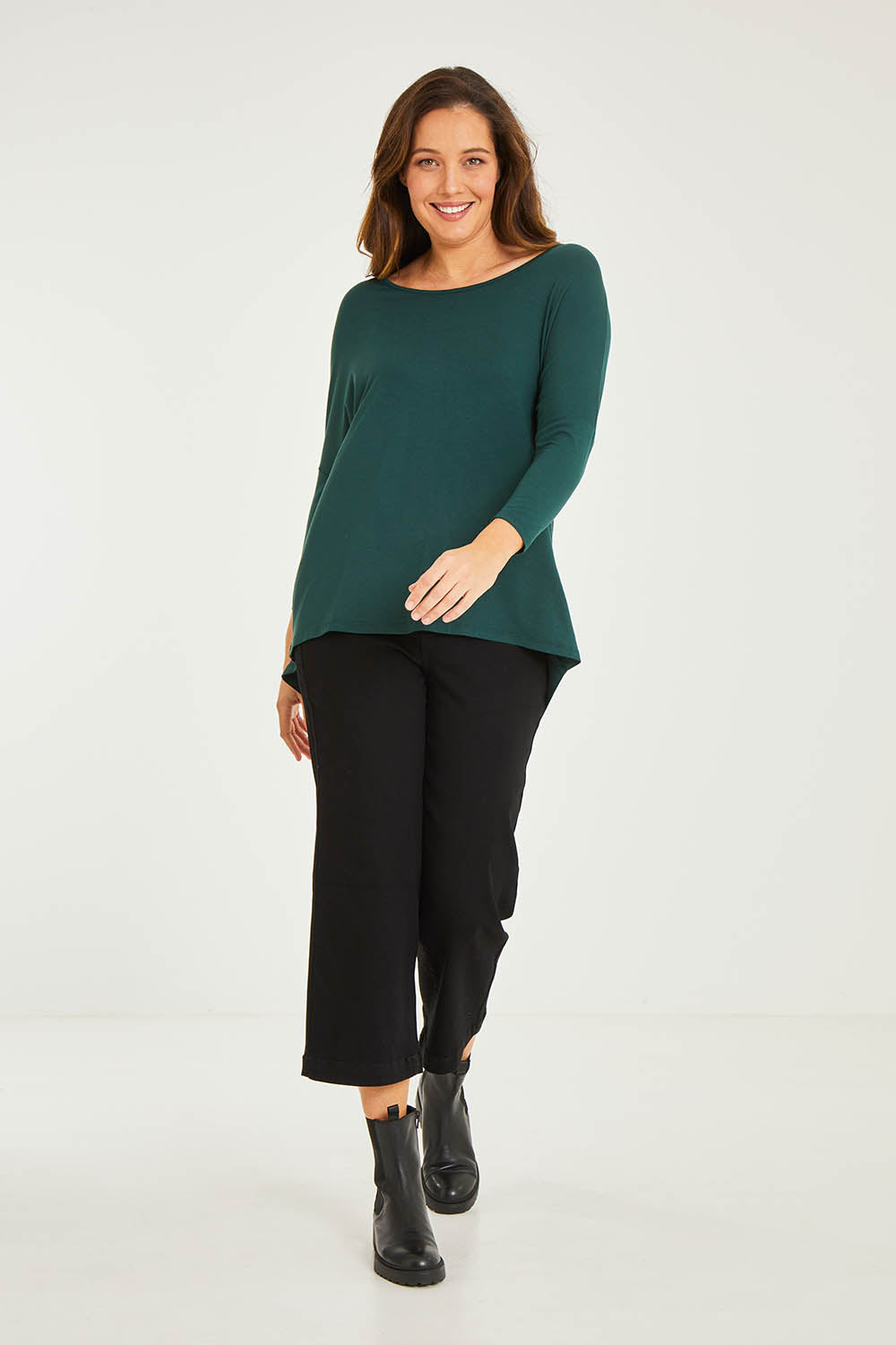 Model Georgia wearing size 10 of the Milan Stretch Top in colour Ivy (Green), from the front, showing the whole outfit