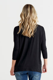 A model wearing the Geneva Tee in colour Black (Black), from the back