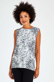 Model Olivia wearing size 10 of the Capri Tank in colour Spotty (White), from the front, cropped image