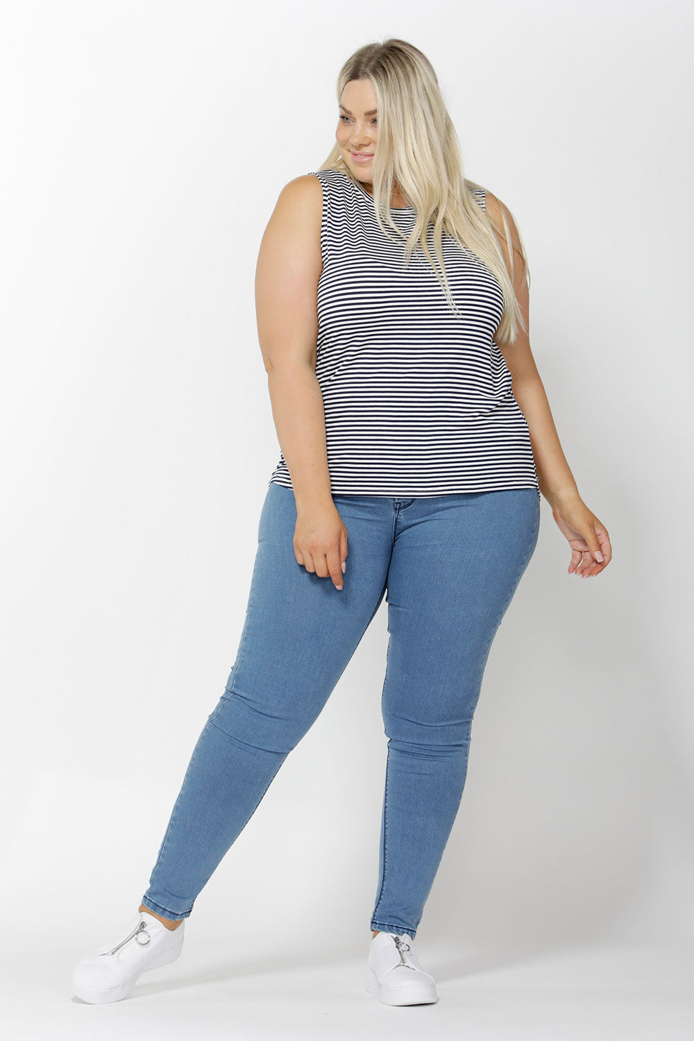 A model wearing the Capri Tank in colour NavyStripe (Blue), from the front, showing the whole outfit